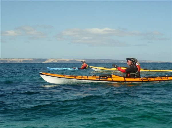 Paddling close inshore to avoid the winds.